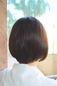 The hairstyle has soft hair affected by soft rebounding. back